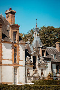 Low angle view of historic building against clear blue sky