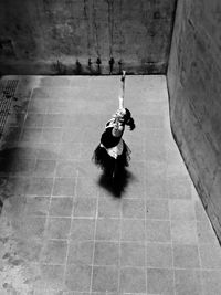 High angle view of woman dancing by wall on floor