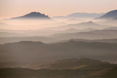 Scenic view of mountains against sky at sunset