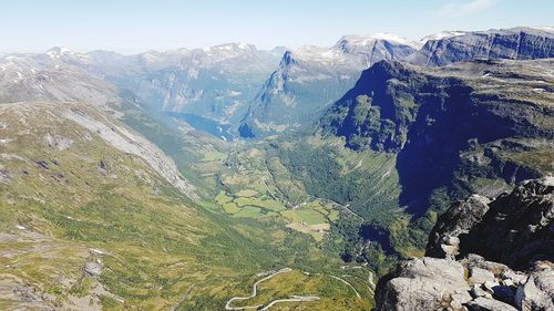 High angle view of valley and mountains against sky