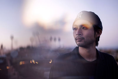 Portrait of young man against sky during sunset