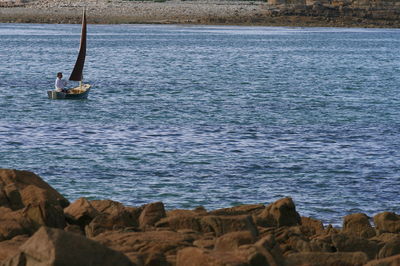 Man sailing boat on sea