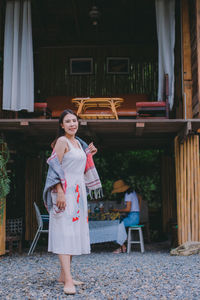 Portrait of woman standing against wall