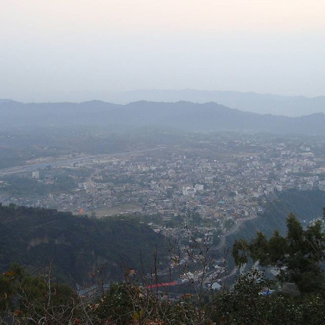 mountain, building exterior, cityscape, built structure, architecture, high angle view, mountain range, city, landscape, crowded, residential district, sky, scenics, residential building, residential structure, tree, nature, hill, town, beauty in nature