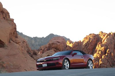 Car on mountain road against clear sky