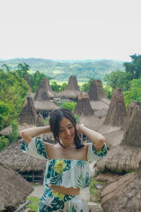 Full length of woman standing on mountain against sky