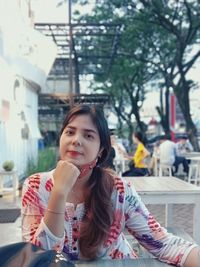 Portrait of woman sitting at outdoors cafe