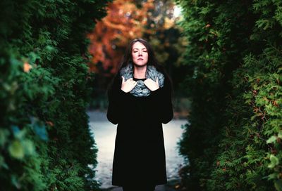 Woman standing in forest