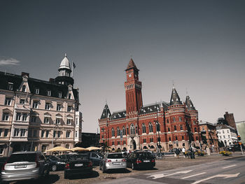 View of buildings and city street against sky