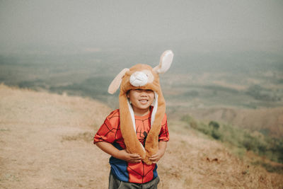 Young man wearing hat standing on land