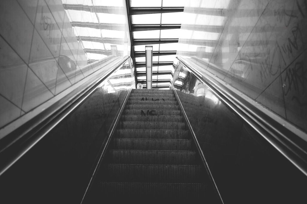 indoors, architecture, built structure, steps and staircases, staircase, steps, railing, the way forward, modern, escalator, diminishing perspective, ceiling, low angle view, building, pattern, no people, vanishing point, high angle view, glass - material, day