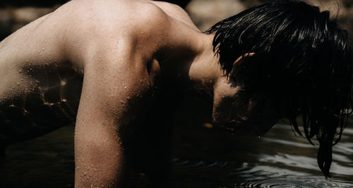 Rear view of shirtless man