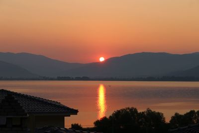 Scenic view of lake against romantic sky at sunset