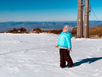 Little boy in the snow of the mountains of sierra nevada