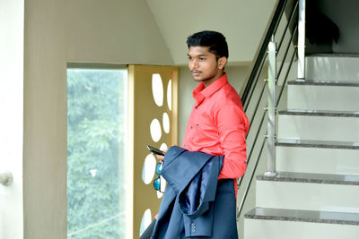 Man in formalwear standing at home