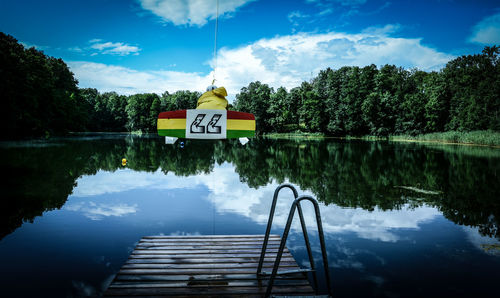 Scenic view of lake and wakeboarder