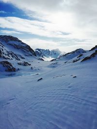 Scenic view of snow covered mountains against sky