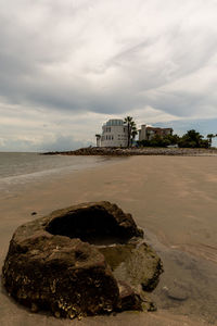 Scenic view of beach by sea against sky