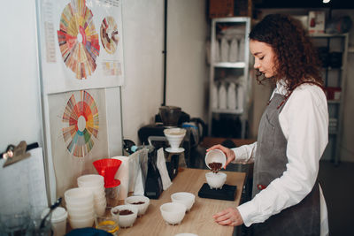 Woman holding coffee cup on table