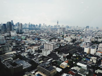 High angle view of buildings in city against sky