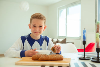 Portrait of boy on table