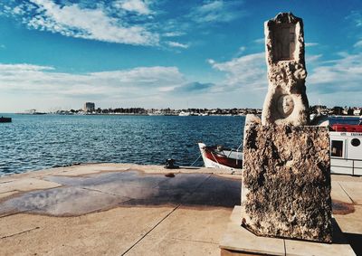 Scenic view of sea against sky in city