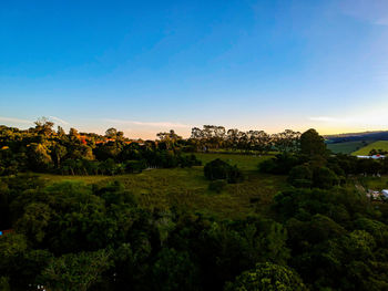 Scenic view of field against sky at sunset