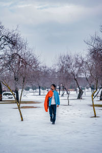 Rear view of boy standing on snow