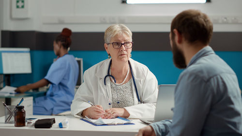 Female doctor with patient in medical clinic