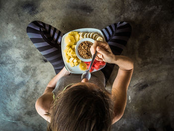 Directly above shot of woman eating breakfast