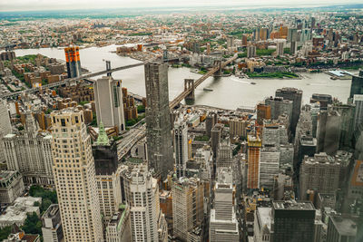 High angle view of modern buildings by river in city