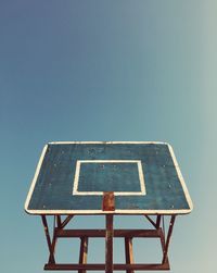 Low angle view of basketball hoop against clear sky