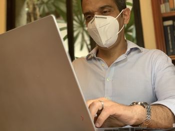 Midsection of man using laptop