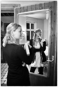 Portrait of young woman sitting on wall