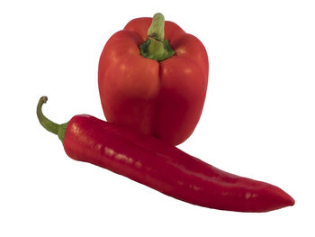 Close-up of red bell peppers against white background