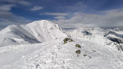 Scenic view of snow mountains against sky