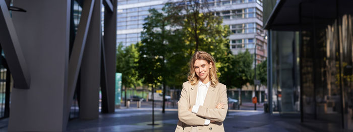 Portrait of woman standing in city