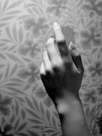 Close-up of person hand on bed