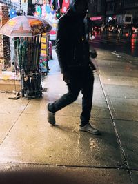 Full length of man walking on street in city