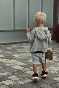 Side view of girl walking on footpath