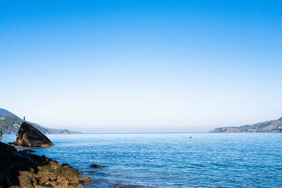 Scenic view of sea against clear blue sky