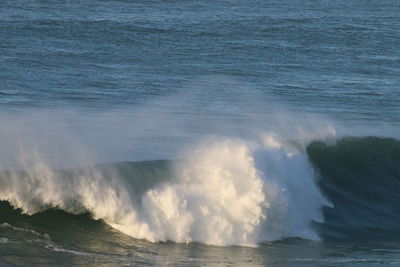 Waves breaking against sea