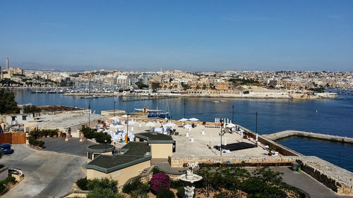 View of cityscape against blue sky
