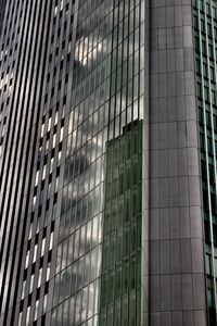 Low angle view of modern glass building in city