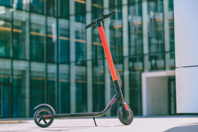 Electric push scooter parked on footpath