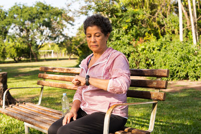 Young man sitting on bench