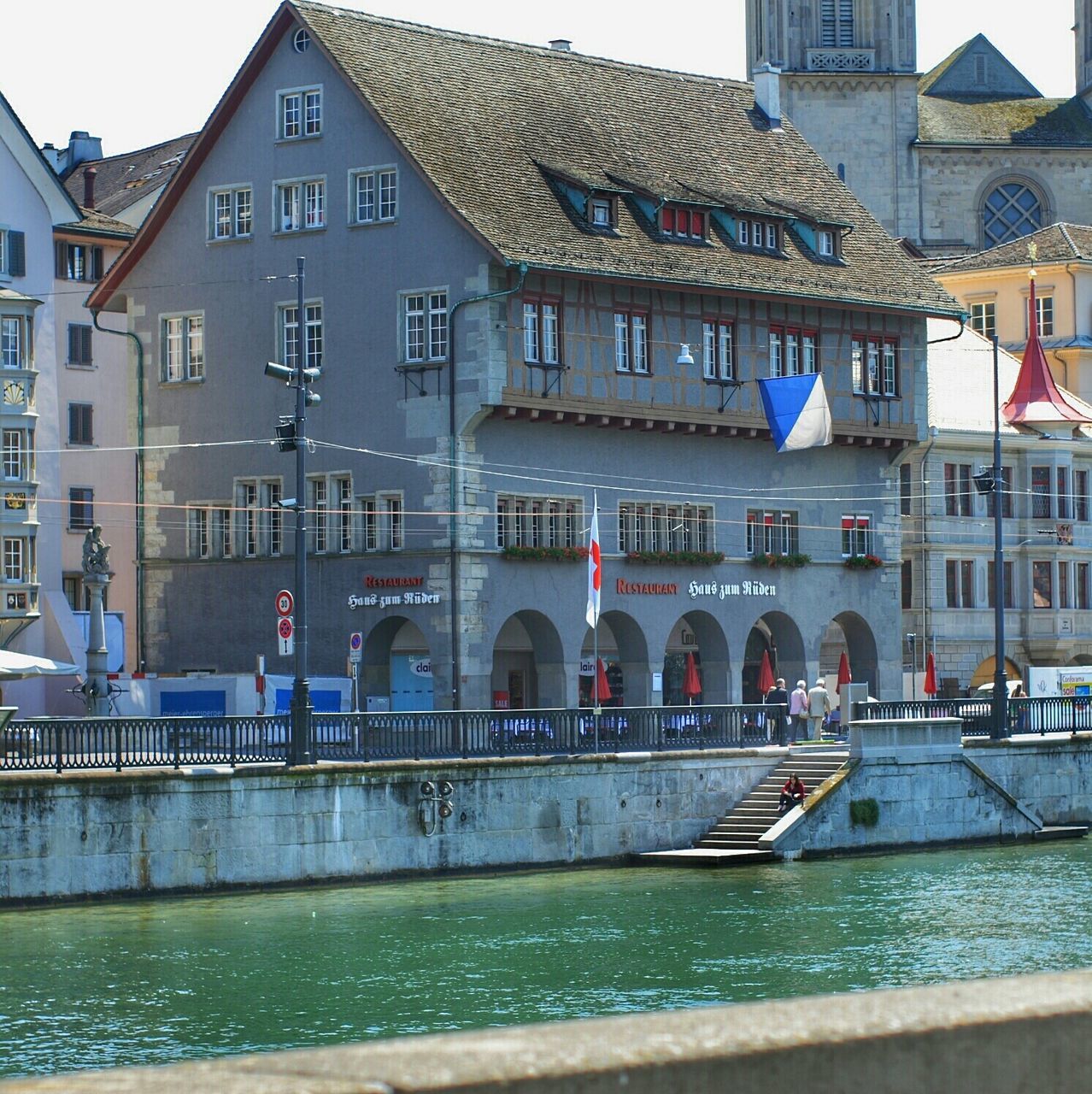 architecture, building exterior, built structure, city, building, water, canal, city life, window, reflection, residential building, transportation, incidental people, day, facade, street, residential structure, outdoors, large group of people