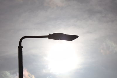 Low angle view of silhouette street light against sky