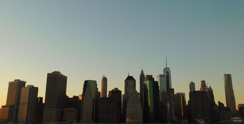 Modern buildings in city against clear sky