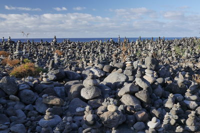 Rocks on beach against sky